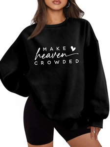 Close-up of MAKE HEAVEN CROWDED text print on black oversized fleece sweatshirt