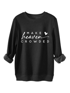 Detail view of black crewneck sweatshirt showing soft fleece lining and white printed letters