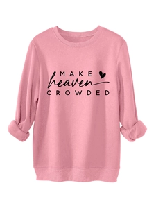 Detailed view of pink sweatshirt featuring Make Heaven Crowded text and a small heart icon
