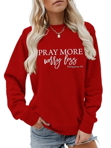 Detail of red crewneck sweatshirt with Pray More Worry Less print and soft cotton fabric