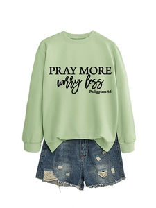 Detail of Pray More Worry Less print on light green long sleeve crewneck sweatshirt