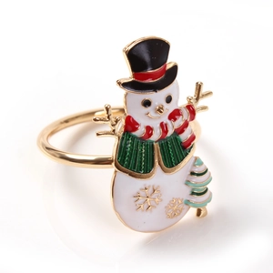 Detailed view of snowman napkin ring with white enamel, festive scarf and golden snowflakes