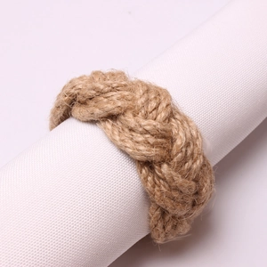 Handmade braided jute rope napkin ring for rustic dining table decor on white fabric