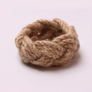 Handwoven natural jute napkin ring with a twisted rope design in rustic farmhouse style
