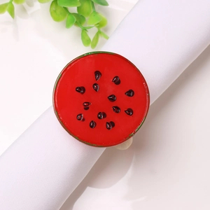 Detailed view of a watermelon napkin ring with red enamel finish and green rim accents