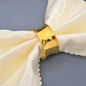 Golden plated alloy napkin ring with elegant beaded edges for formal table settings