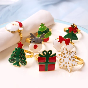 Detailed view of assorted Christmas napkin rings with Santa and Reindeer on a white plate