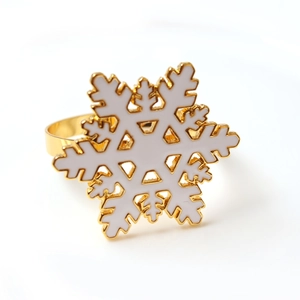 Detailed view of white snowflake napkin ring with golden base for Christmas table decor