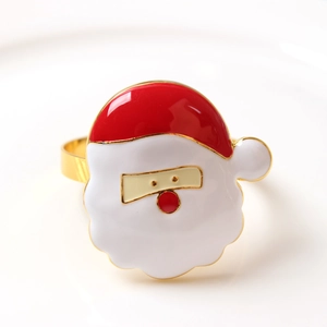 Macro view of Santa Claus napkin ring with colorful enamel finish on a white plate