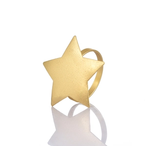 Matte gold star napkin ring with frosted metallic finish on white reflective background