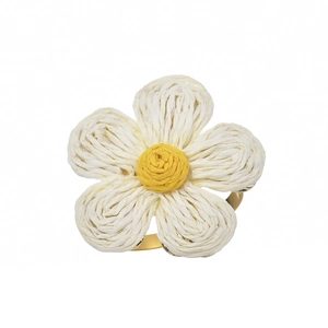 Handcrafted woven flower napkin ring with white petals and golden metal holder for tables