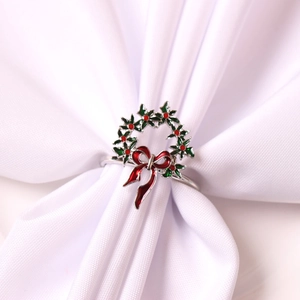Gros plan d'un rond de serviette en forme de couronne de Noël avec nœud rouge