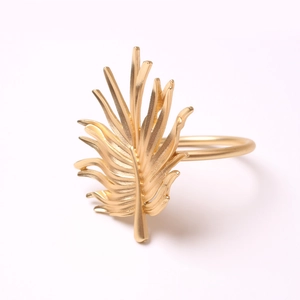 Matte gold palm leaf napkin ring with detailed texture for elegant table settings