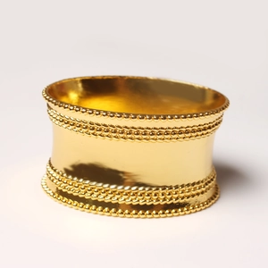 Golden wide napkin ring with decorative beaded edges and a polished zinc alloy finish