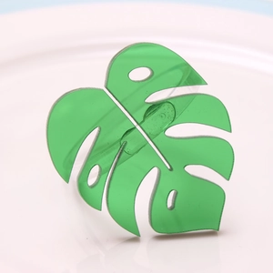 Green translucent Monstera leaf napkin ring with modern tropical design for table decor