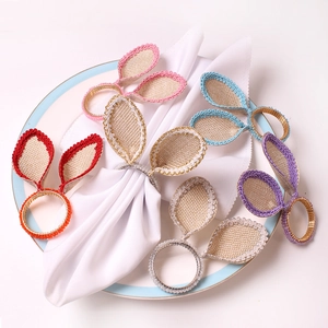 Detail of colorful bunny ear napkin rings with intricate woven edges for Easter tables