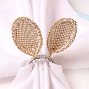 Detail of burlap bunny ear napkin ring with white bead loop and gold trim decor