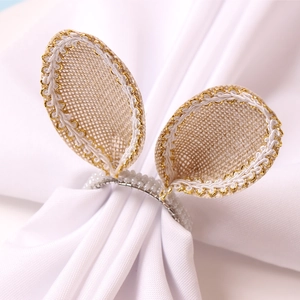 Detailed view of linen bunny ear napkin ring with braided trim and white beaded loop
