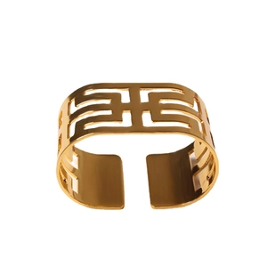 Golden hollow geometric metal napkin ring with elegant wide-cuff design on white background