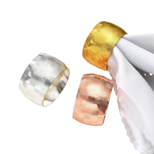 Three-piece metal drum napkin rings in gold, silver, and rose gold with geometric textures