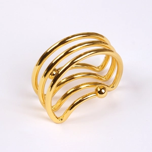 Modern semi-circle golden metal napkin ring with a multi-layer wave design on white background