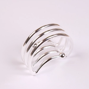 Macro shot of multi-layer silver spring napkin ring with wavy metal coils and bead ends