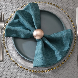 Rose gold minimalist metal napkin ring with frosted texture on elegant dinnerware