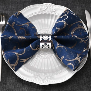Intricate hollow snowflake napkin ring in silver finish on a luxury holiday table setting