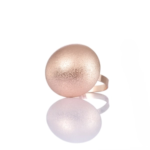 Detail of rose gold napkin ring featuring a matte sandblasted domed metal finish
