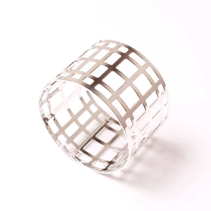 Macro view of geometric silver napkin ring with modern hollow mesh grid metal design