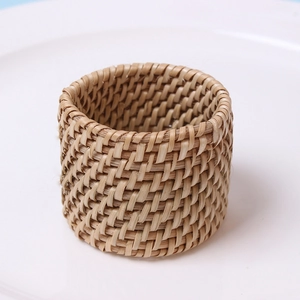 Handmade bamboo napkin ring in natural brown weave on a white plate for table decor