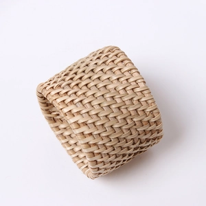 Close-up of handmade natural bamboo woven napkin ring showing detailed texture