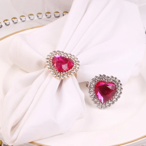 Close-up of pink heart rhinestone napkin rings in gold and silver for festive table decor