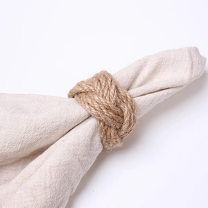 Macro shot of handcrafted natural jute fiber napkin ring tied in a rustic knot style