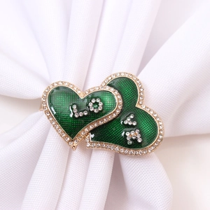 Golden heart napkin ring with green enamel, rhinestones and LOVE lettering decoration