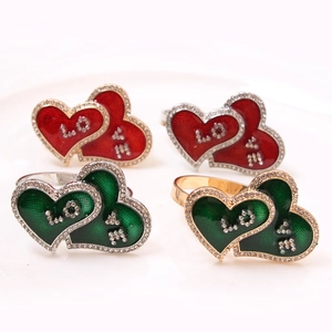 Macro view of heart-shaped napkin rings with enamel and LOVE rhinestones detail