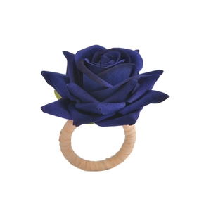 Elegant deep blue rose napkin ring with a natural woven rattan holder for table decor