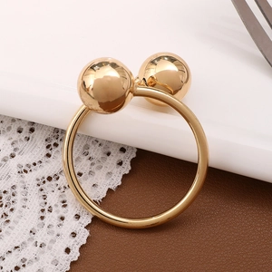 Elegant gold napkin ring featuring a minimalist double bead design on a lace background