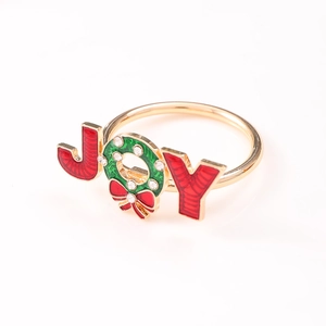 Golden Merry Christmas napkin ring featuring JOY letters with rhinestones and enamel wreath