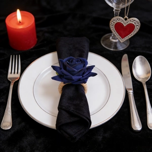 Blue rose napkin ring with woven base on black velvet for a romantic table setting