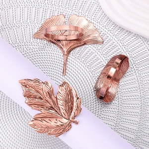 Rose gold leaf napkin rings in ginkgo and maple designs on purple ribbon background