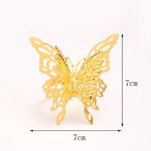 Golden butterfly napkin ring with hollow design and 7cm dimensions on white background