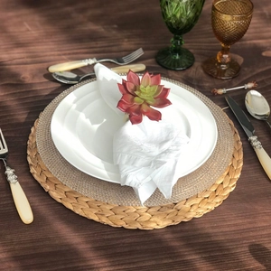 Detailed view of handmade succulent napkin ring on white linen napkin on table setting
