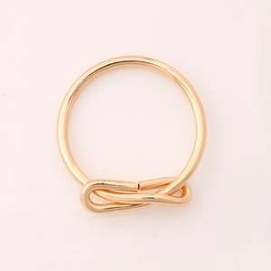 Elegant gold metal bow-knot napkin ring featuring a creative woven design for table decor