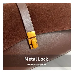 Detalle del cierre metálico dorado y la textura de cuero en este bolso marrón de moda
