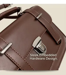 Detail of vintage brown shoulder bag showing a 3D gunmetal twist-lock and smooth finish