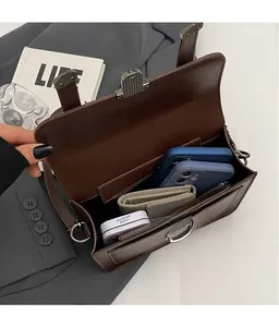 Top view of brown leather bag interior showing spacious storage for phones and wallet