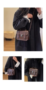 Detail of vintage dark brown messenger bag with metal buckle and adjustable shoulder strap