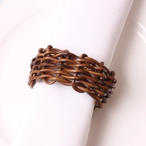 Modern brown woven napkin ring on a white linen cloth for elegant table setting décor