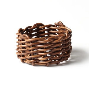 Brown woven rattan napkin ring in a minimalist style for modern table decoration